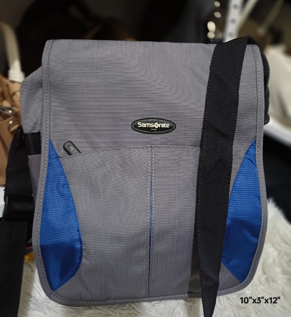 Samsonite Messenger Bag Sling Bag (Category: Sling Bags) located in Bocaue. Submitted by bags.and.beyond (Listing ID 1465887726, Image 1). Description: Samsonite Messenger Bag in a sleek gray color with sporty blue accents and a durable black adjustable crossbody strap. Perfect for daily commuting, school, travel, or casual use. Color: Gray with Blue panels and Black strap Dimensions: 10" x 3" x 12" (Compact yet spacious enough for daily essentia