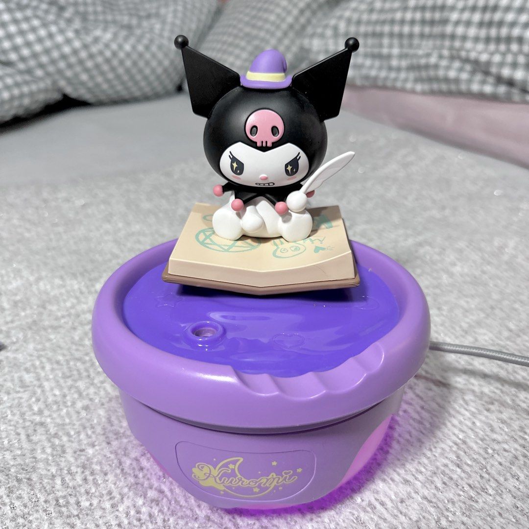 Sanrio Martube Kuromi Magic Book Aroma Diffuser Humidifier (Category: Designer & Blind Box Toys) located in Paranaque City. Submitted by hershey_august (Listing ID 1465939166, Image 1). Description: - Purple Kuromi desktop humidifier and aroma diffuser - Features an adorable Kuromi figure sitting on a spell book - Includes a matching card booklet and holographic feather sticker - USB-powered for easy plug-and-play use - Emits a cute purple glow w