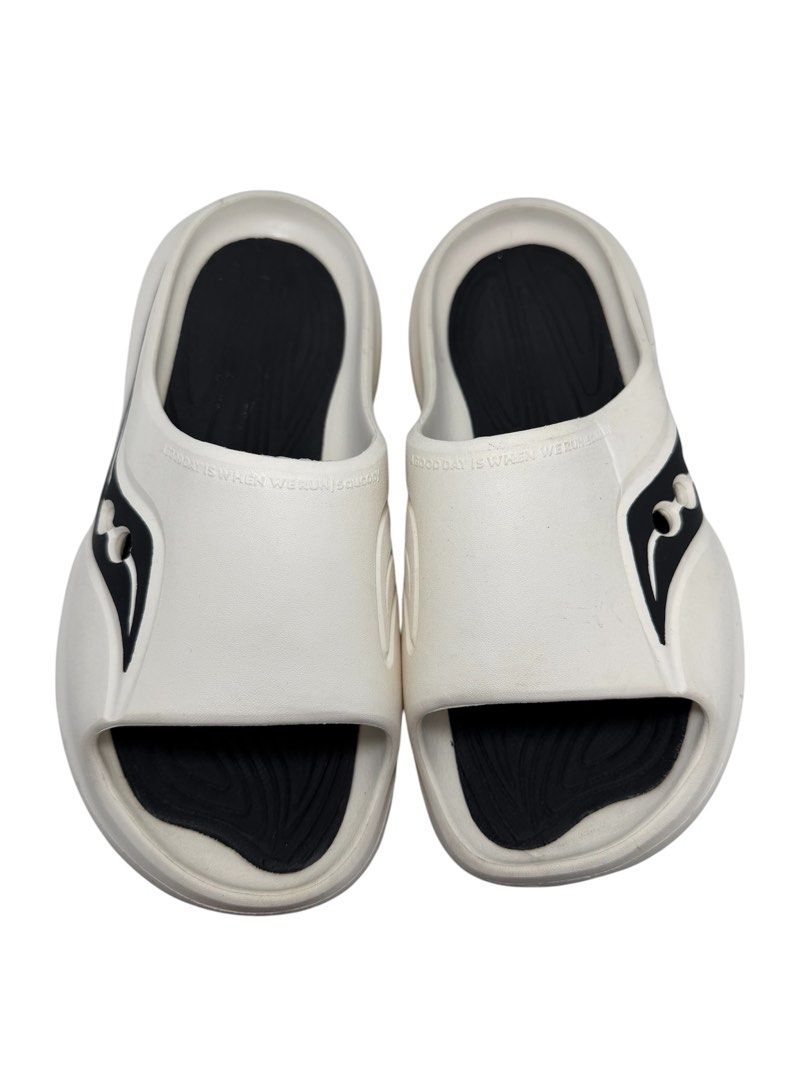 Saucony Unisex Slides (Category: Slippers & Slides) located in Baguio. Submitted by jerome09965737 (Listing ID 1465950364, Image 2). Description: - Brand: Saucony - Style: Slide sandals, slip-on - Color: White and black - Size: US 8.5 / UK 7.5 / EUR 42 - Gender: Unisex - Features: Cushioned footbed, textured outsole, brand logo on side and strap - Condition: Normal wear on the soles.
