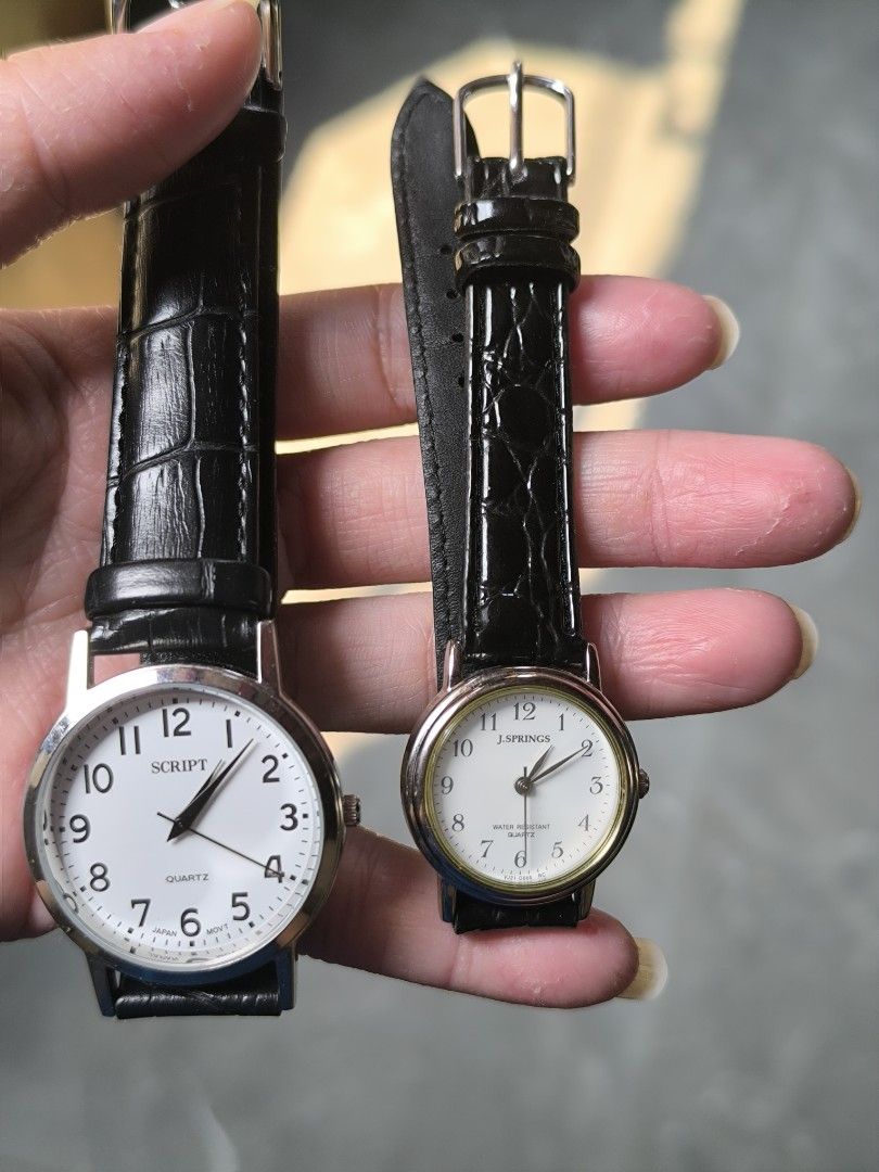 Preloved Watch (Category: Women's Watches) located in Manila. Submitted by sxynss (Listing ID 1465859080, Image 2). Description: - Set of 2 classic quartz wristwatches - Features stylish black leather-textured straps with standard buckle closures - Left Watch: White dial signed 'Script' with bold black Arabic numerals and Japan movement - Right Watch: Smaller white dial signed 'J.Springs' with gold-tone bezel trim and water-resistant quartz label