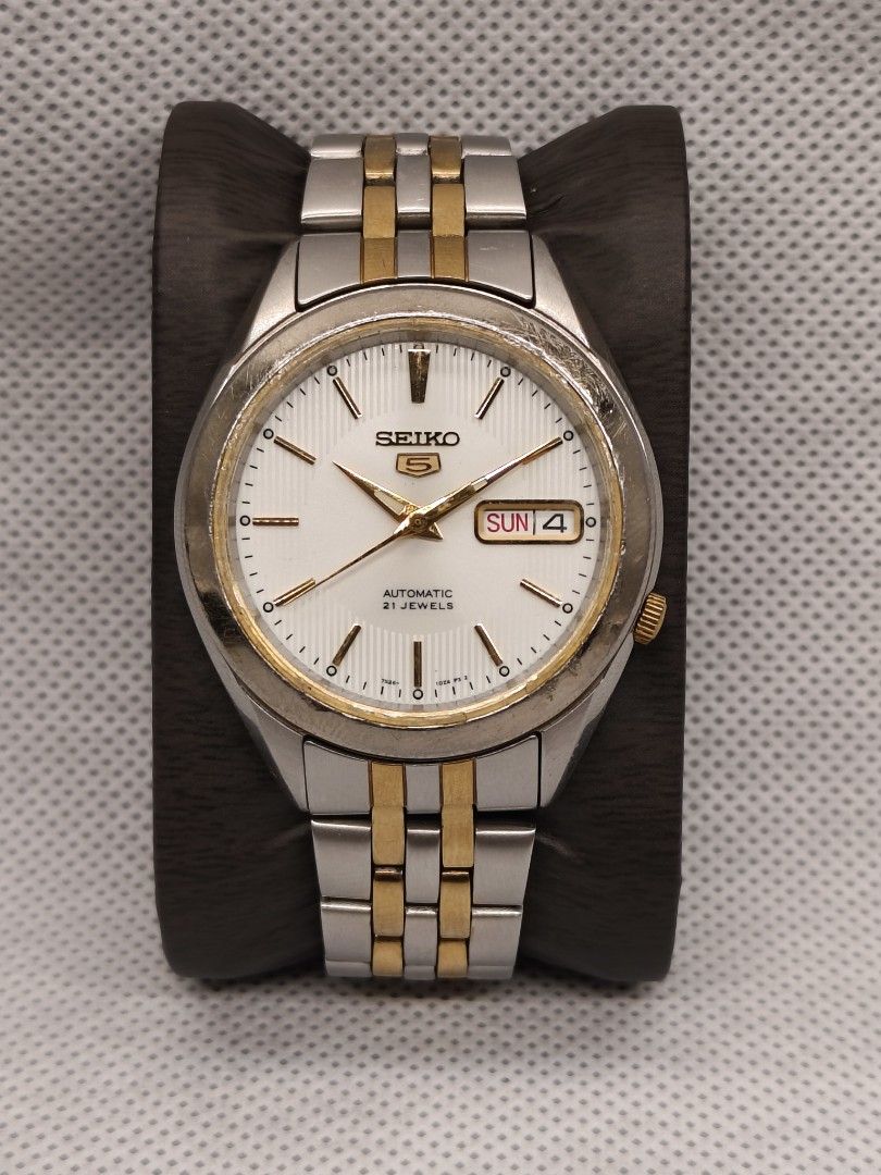 Seiko 5 Automatic 21 Jewels (Model: SNKL24) (Category: Men's Watches) located in Pasig City. Submitted by timepiece-and-co (Listing ID 1465794500, Image 1). Description: Specifications Movement: Seiko Caliber 7S26 Automatic (Self-winding, 21 Jewels, ~41 hours power reserve) Case Diameter: 38 mm Case & Bracelet: Two-tone stainless steel with a gold-plated bezel and matching gold-accented center links. Dial Features: White/silver sunray dial with l