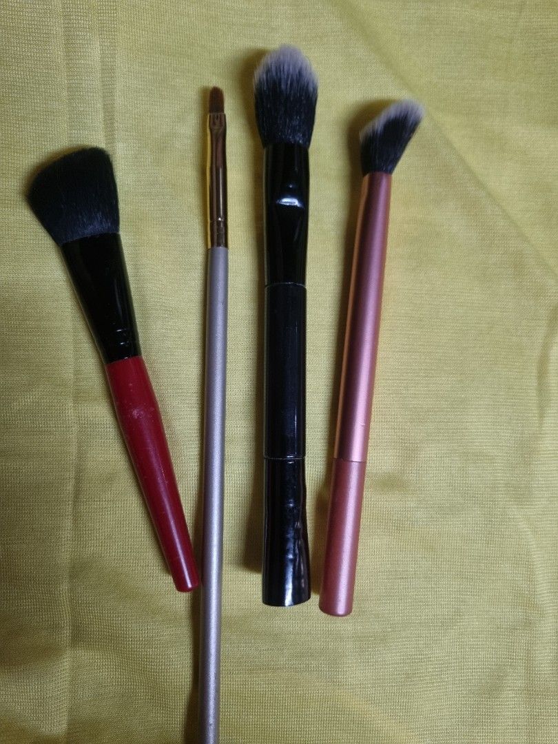 Set of four assorted makeup brushes (Category: Makeup) located in Manila. Submitted by monya111 (Listing ID 1465763257, Image 1). Description: - 4-piece makeup brush bundle - Includes: red angled brush, slim silver lip brush, black double-ended brush, and pink angled brush - Soft synthetic bristles on all items - Ideal for foundation, contouring, and precision detail work - Condition: Handles show minor signs of previous handling and use, perfect