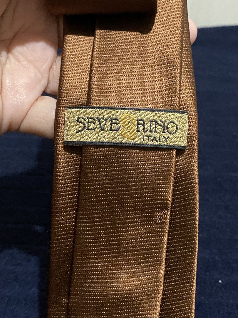 Severino Italy Brown Silk Tie (Category: Ties) located in Manila. Submitted by resi.diaz (Listing ID 1465862622, Image 3). Description: - Brand: Severino Italy - Material: 100% Pure Silk - Color: Solid Brown with textured ribbed finish - Style: Classic width blade, standard adult length - Condition: Clean stitching and excellent quality construction.