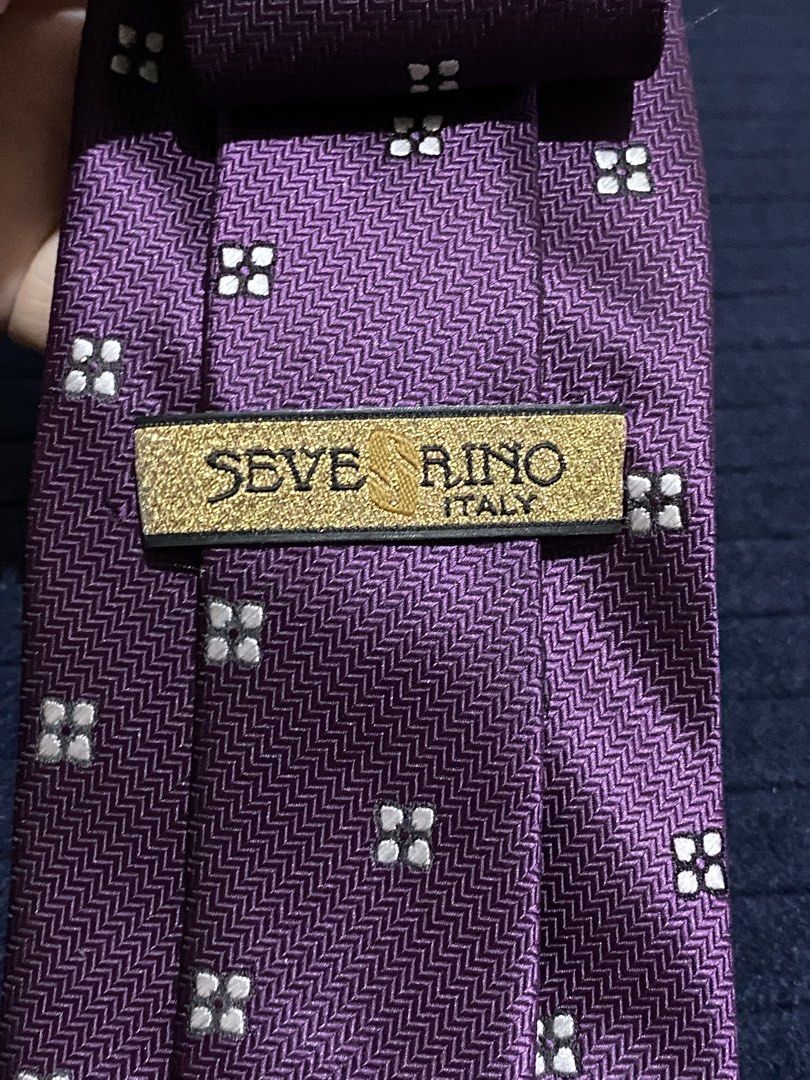 Severino Italy Purple Microfiber Necktie (Category: Ties) located in Manila. Submitted by resi.diaz (Listing ID 1465897557, Image 3). Description: - Brand: Severino Italy - Color: Rich purple with geometric square pattern and chevron textured background - Material: 100% microfiber (smooth fabric) - Size: Standard width tail - Features: Easy to knot, holds shape well - Best for: Office wear or formal events.