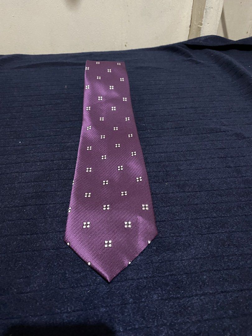 Severino Italy Purple Microfiber Necktie (Category: Ties) located in Manila. Submitted by resi.diaz (Listing ID 1465897557, Image 1). Description: - Brand: Severino Italy - Color: Rich purple with geometric square pattern and chevron textured background - Material: 100% microfiber (smooth fabric) - Size: Standard width tail - Features: Easy to knot, holds shape well - Best for: Office wear or formal events.