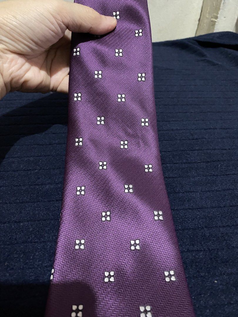 Severino Italy Purple Microfiber Necktie (Category: Ties) located in Manila. Submitted by resi.diaz (Listing ID 1465897557, Image 2). Description: - Brand: Severino Italy - Color: Rich purple with geometric square pattern and chevron textured background - Material: 100% microfiber (smooth fabric) - Size: Standard width tail - Features: Easy to knot, holds shape well - Best for: Office wear or formal events.