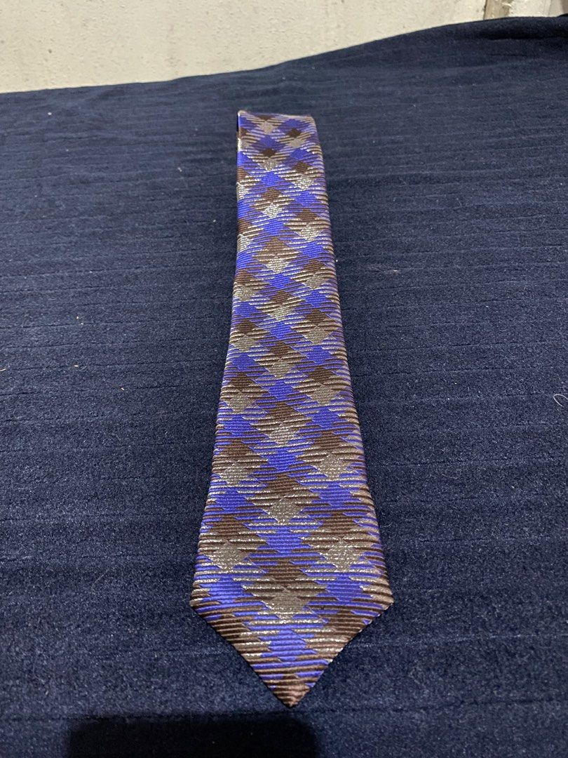 Severino Italy Silk Necktie Blue Brown Pattern (Category: Ties) located in Manila. Submitted by resi.diaz (Listing ID 1465860663, Image 1). Description: - Brand: Severino Italy - Material: 100% pure silk with a rich sheen and textured fabric - Design: Striking blue and brown geometric pattern - Fit: Standard width and length - Condition: Clean labels intact on the back - Style Tip: Great piece to add some color to your suit.
