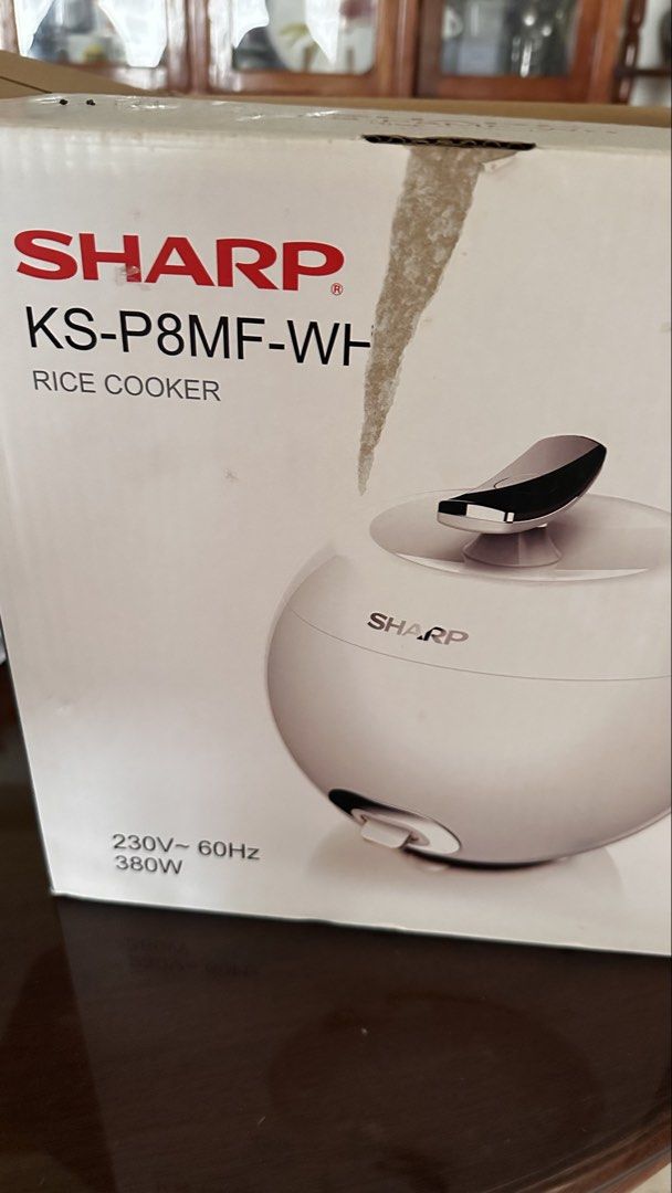 Sharp KS-P8MF-WH Rice Cooker (Category: Cookers) located in Manila. Submitted by dyelizabet65197 (Listing ID 1465785391, Image 2). Description: - Brand: Sharp - Model: KS-P8MF-WH - Color: White (Apple-shaped design) - Power: 380W, 230V, 60Hz - Features: Chrome handle lid, easy single-switch operation - Condition: Unit is great, original box included with some shelf wear.