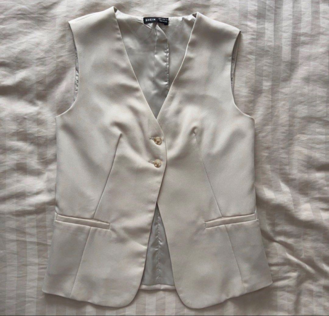 SHEIN Beige Tailored Vest Size S (Category: Sleeveless) located in Pasig City. Submitted by jenscloset86 (Listing ID 1465906723, Image 2). Description: Brand: SHEIN Size: Small • Used TWICE. Looks new. • Excellent quality. • No flaws, no damages. Dimension: Length: 24.5” Bust: 34” Waist: 34” - Beige vest from SHEIN - Two front buttons - Two front pocket details - Fully lined interior - Ideal for layering over tops or dresses - Versatile wardrobe 