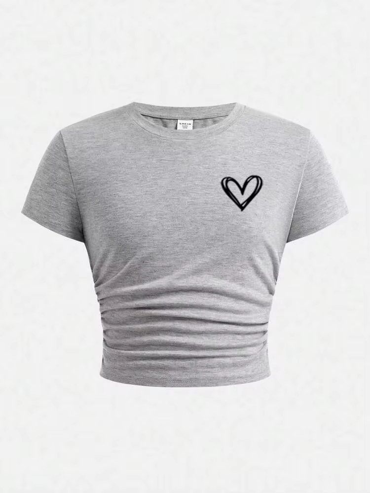 Shein Gray Cropped Shirt (Category: Shirts) located in Manila. Submitted by dianafayesimbre (Listing ID 1465841312, Image 1). Description: - Colour: Grey with black hand-drawn heart print - Style: Short-sleeve crop top with round neckline and straight hem - Material: Soft and stretchy fabric for all-day comfort - Fit: Perfect for casual outfits, pairs easily with high-waisted jeans or skirts - Condition: Brand new - Best fits xxs to medium frame.