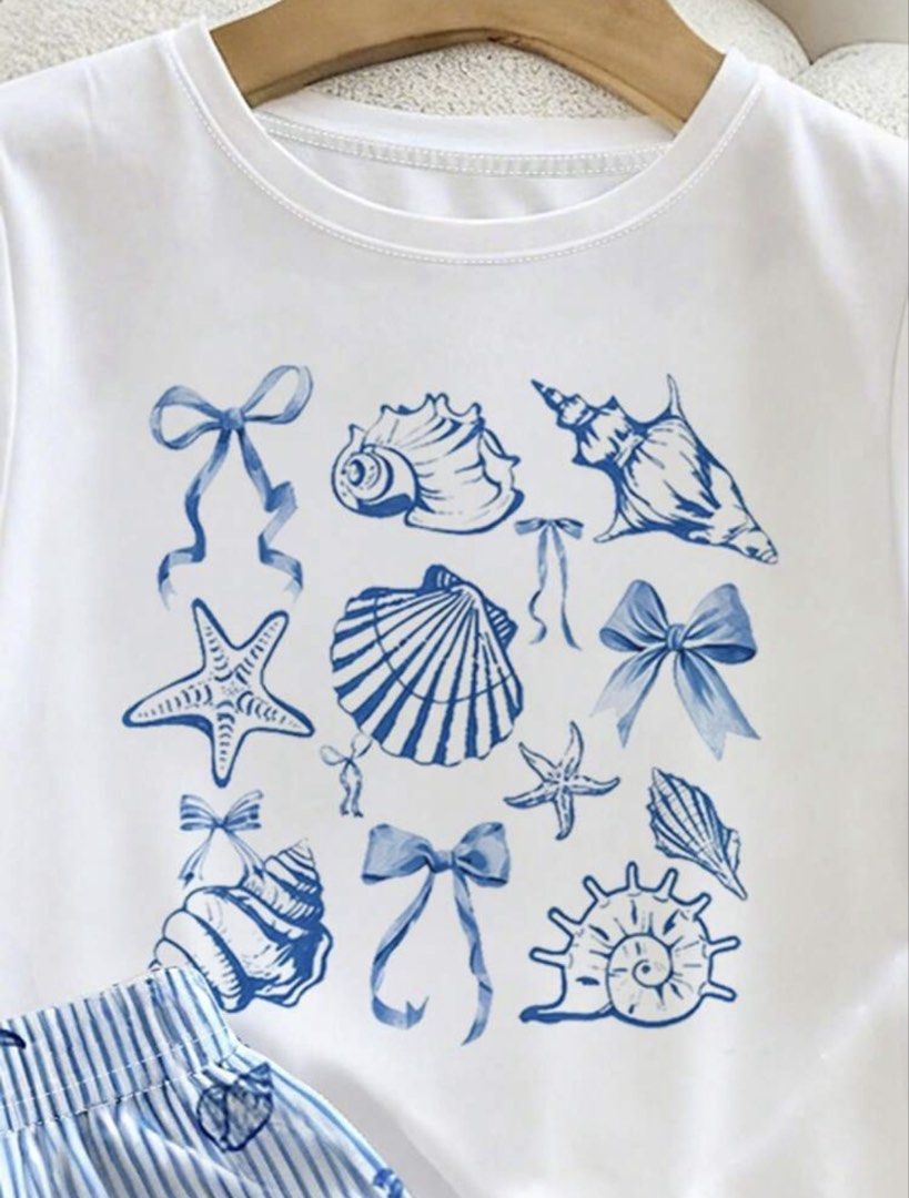 Shein White Coquette Seashell Print Shirt (Category: Sets or Coordinates) located in Manila. Submitted by dianafayesimbre (Listing ID 1465831810, Image 3). Description: - Size: 12Y on tag but fits xxs to semi medium on womens - Details: Cute nautical shell and bow graphics on tee - Condition: Brand new.