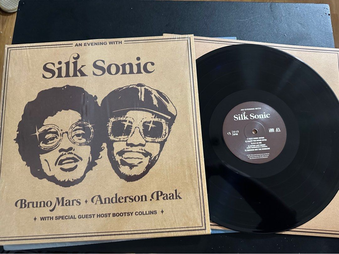 Silk Sonic An Evening With Silk Sonic Vinyl Record (Category: Vinyls) located in Balagtas. Submitted by cosmicshark.83f374 (Listing ID 1465882818, Image 2). Description: - Artist: Bruno Mars & Anderson.Paak (Hosted by Bootsy Collins) - Album: An Evening With Silk Sonic - Label: Atlantic Records - Format: Vinyl Record (Black LP) - Packaging: Brown cover design featuring artist illustrations and tracklist label - Condition: Brand new and authentic 