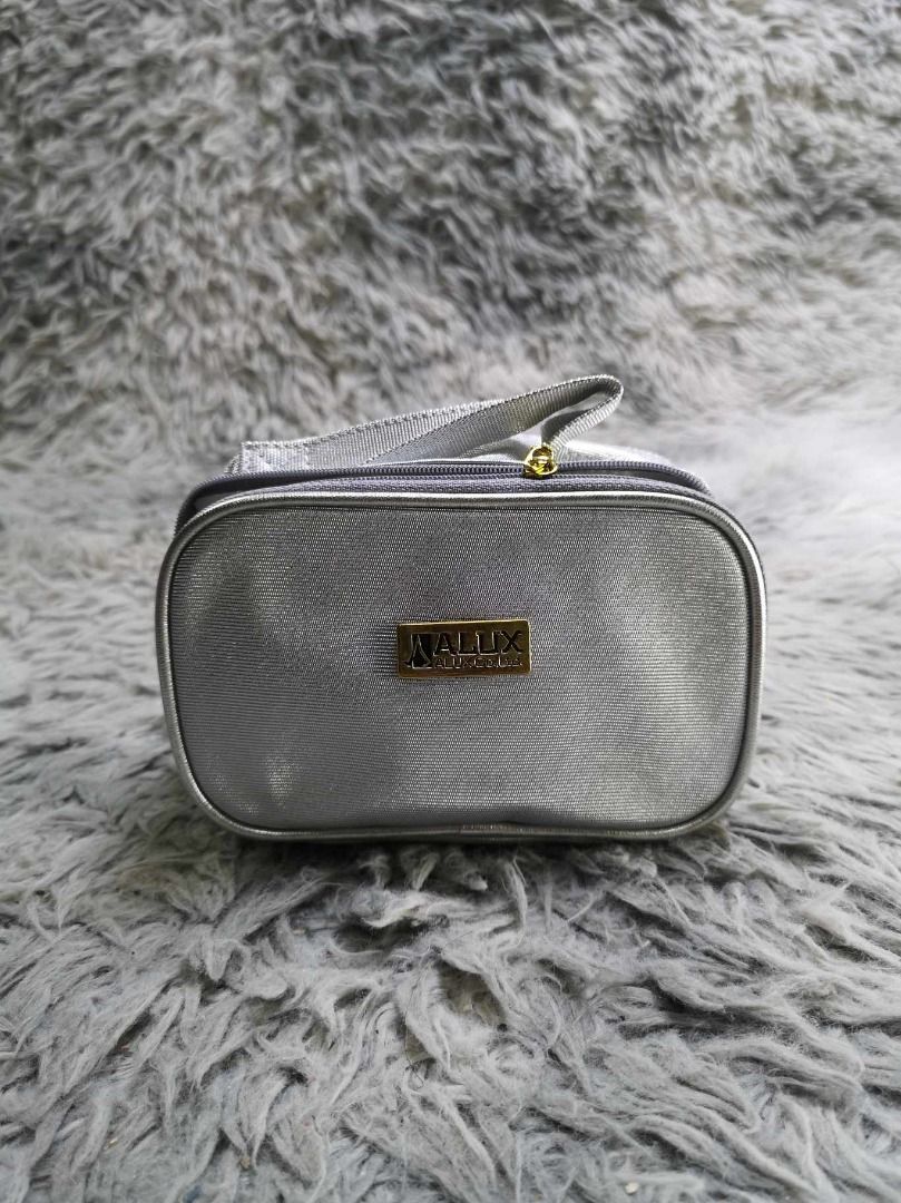 Silver Colored Metallic Finish Cosmetic Pouch (Category: Purses & Pouches) located in Santa Cruz. Submitted by jmy_surplus.2 (Listing ID 1465885648, Image 1). Description: Size ; L - 4.1 W - 6.6 Color ; Silver Type ; Pouch Brand ; No brand Material ; Synthetic Style ; Silver Zip Around With Top handle Cosmetic pouch LR 129 JMY 5 Batch #224.