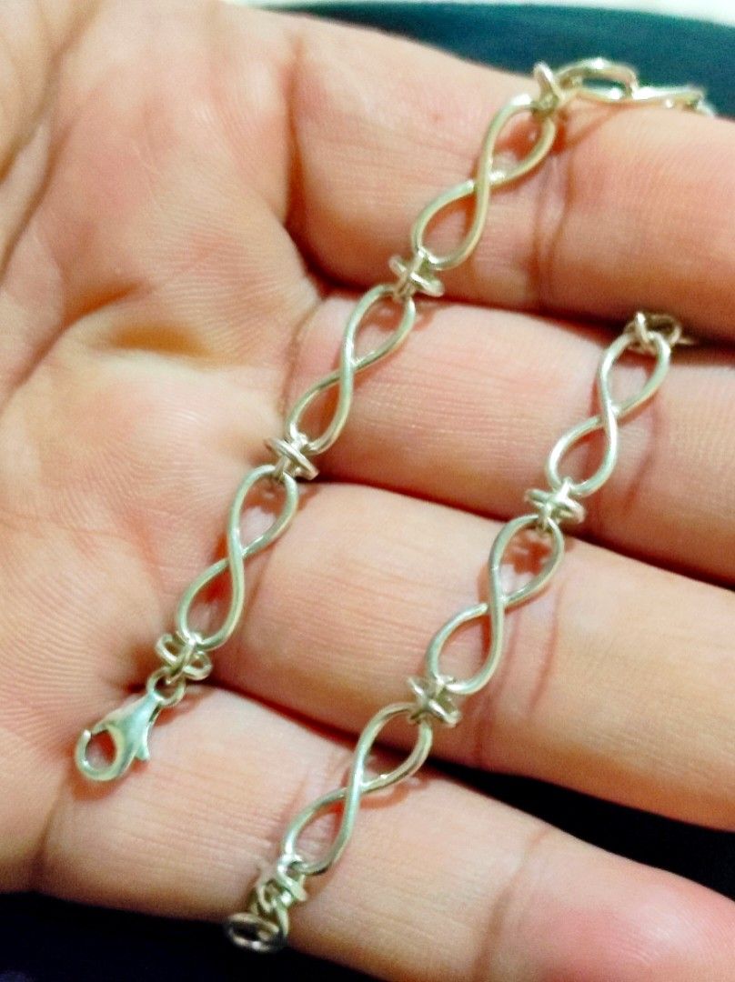 Silver Infinity Link Chain Bracelet with Lobster Clasp (Category: Bracelets) located in Cavite. Submitted by noblepenguin_6c8662 (Listing ID 1465314610, Image 1). Description: - Design: Silver 925 connected infinity symbols with delicate cross-like spacers - Closure: Standard lobster claw clasp with an extension chain for adjustable length -Size 8 - Condition: Clean metal finish, no obvious tarnish or scratches - Fit: Sits nicely and comfortably 
