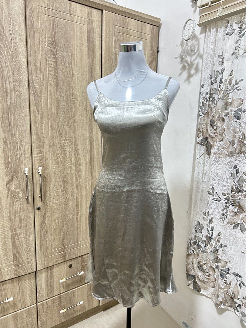 Silver Satin Spaghetti Strap Slip Dress (Category: Dresses) located in Cavite. Submitted by cl09-39734 (Listing ID 1465820144, Image 2). Description: - Color & Fabric: Silver satin, fluid and shiny with a slight stretch - Design: Spaghetti straps, square neckline - Length: Midi length - Perfect for: Parties, date nights, and night outs - Condition: Excellent, ready to wear - Mode of Payment: GCash, BPI, or COD via LBC/J&T - Shipping: Ships out wi