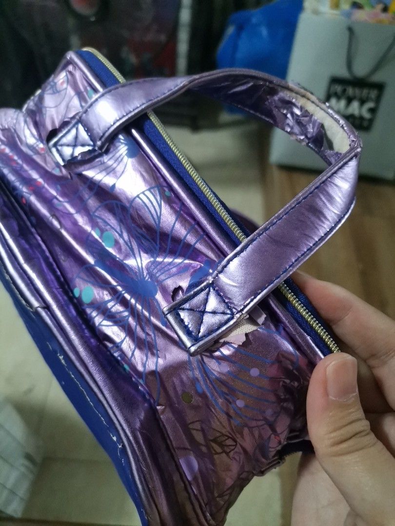 Smiggle Reversible Sequin Handbag Style Pencil Case (Category: Purses & Pouches) located in Makati City. Submitted by kookybearsstuff (Listing ID 1465863736, Image 3). Description: - Authentic Smiggle brand - Adorable mini handbag design with dazzling pink sequins on the front - Purple metallic back and handles with a cute butterfly graphic - Vibrant blue fabric bottom and interior lining - Signature metal Smiggle zipper charm and embroidered fab