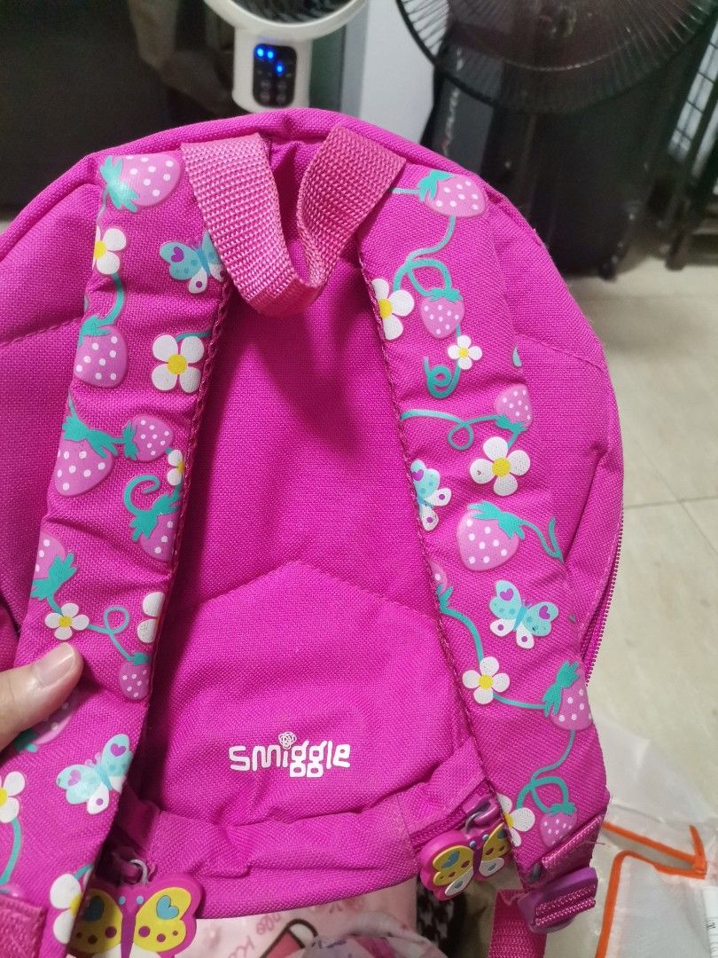 Smiggle Strawberry Face Kids Backpack (Category: Backpacks) located in Makati City. Submitted by kookybearsstuff (Listing ID 1465828756, Image 3). Description: - Authentic Smiggle strawberry-shaped backpack in vibrant pink and blue - Features adorable eyes, smile, flower appliques, and white polka dot details - Straps feature cute strawberry and butterfly prints with embroidered Smiggle logo - Interior includes a convenient pink mesh pocket and n