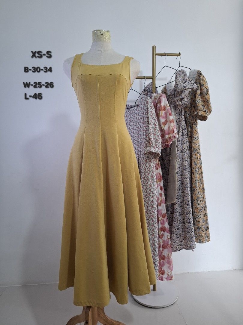 Solid Yellow Midi Dress Square Neck Sleeveless (Category: Dresses) located in Manila. Submitted by al_drei (Listing ID 1465951878, Image 1). Description: - Color: Solid Yellow - Style: Sleeveless square neckline midi dress with A-line skirt and fitted bodice - Size: XS to S - Measurements: Bust 30-34", Waist 25-26", Length 46" - Condition: Clean, vibrant fabric with no patterns - Perfect for: Sunny days, brunch, or casual outings - DM for more in