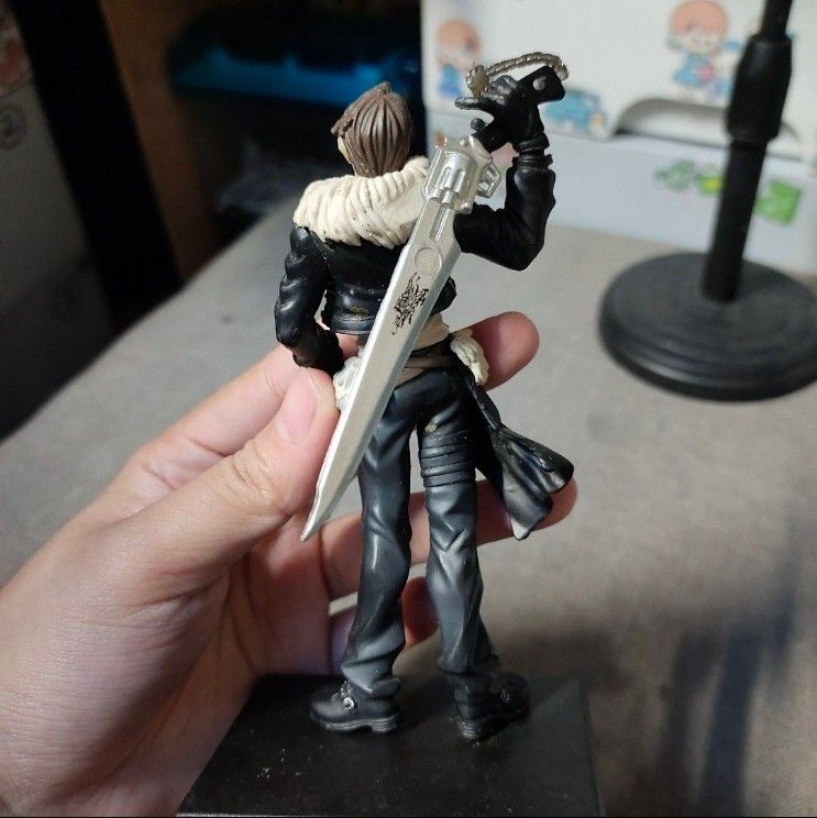 Squall Leonhart Final Fantasy VIII Trading Figure (Category: Figurines & Statues) located in Quezon City. Submitted by dncpreloved (Listing ID 1465772401, Image 3). Description: - Authentic Squall Leonhart figure from Final Fantasy VIII - Detailed sculpt featuring his signature gunblade - Iconic black jacket with fur collar and grey pants - Includes original black base stand (stands firmly upright) - Condition: Minor paint wear and dust from disp