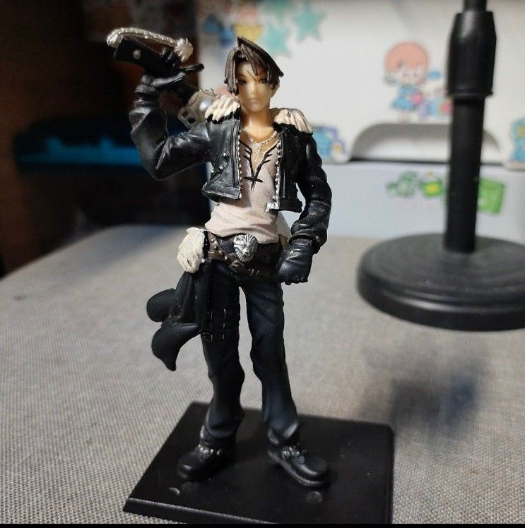 Squall Leonhart Final Fantasy VIII Trading Figure (Category: Figurines & Statues) located in Quezon City. Submitted by dncpreloved (Listing ID 1465772401, Image 2). Description: - Authentic Squall Leonhart figure from Final Fantasy VIII - Detailed sculpt featuring his signature gunblade - Iconic black jacket with fur collar and grey pants - Includes original black base stand (stands firmly upright) - Condition: Minor paint wear and dust from disp