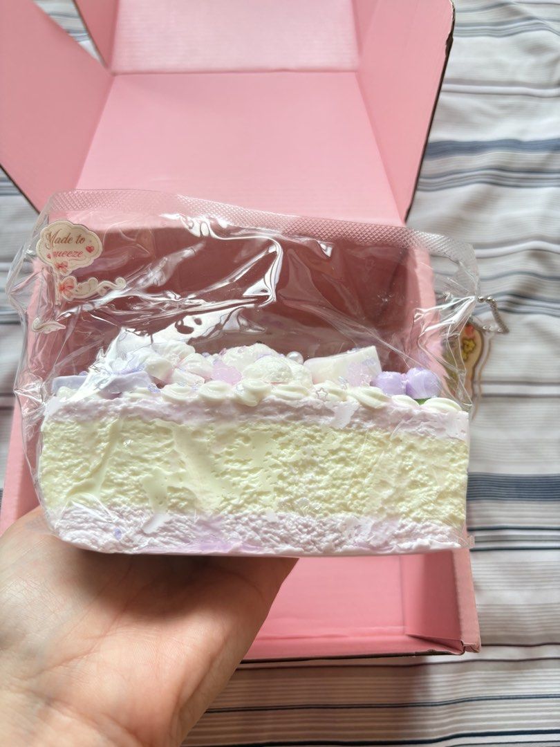 Squishy Pastel Purple Bear Cake Slice Squishy Toy (Category: Designer & Blind Box Toys) located in Bacoor. Submitted by rnsphmllr (Listing ID 1465912837, Image 3). Description: Firm, fast rise - Adorable pastel purple and white cake slice squishy toy - Detailed with a cute bear figure, dainty flowers, and sweet toppings - Made with ultra-soft, slow-rising foam material - Brand new and sealed in its original pink box packaging - Includes a matchin