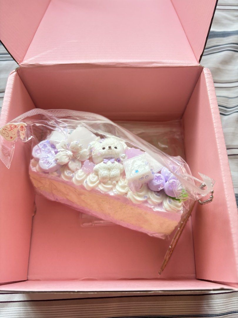Squishy Pastel Purple Bear Cake Slice Squishy Toy (Category: Designer & Blind Box Toys) located in Bacoor. Submitted by rnsphmllr (Listing ID 1465912837, Image 2). Description: Firm, fast rise - Adorable pastel purple and white cake slice squishy toy - Detailed with a cute bear figure, dainty flowers, and sweet toppings - Made with ultra-soft, slow-rising foam material - Brand new and sealed in its original pink box packaging - Includes a matchin