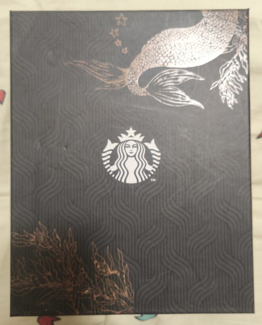 Starbucks Gold Planner 2024 (Category: Stationery & School Supplies) located in Dasmarinas. Submitted by alleethrifthauls (Listing ID 1465822981, Image 1). Description: - Rose gold Starbucks planner in pristine condition - Includes matching black pen and original dark box with Siren logo - Textured cover with elegant mermaid scale and seaweed embossing - Built-in pen holder loop for convenience - Clean and organized layout inside for easy plannin