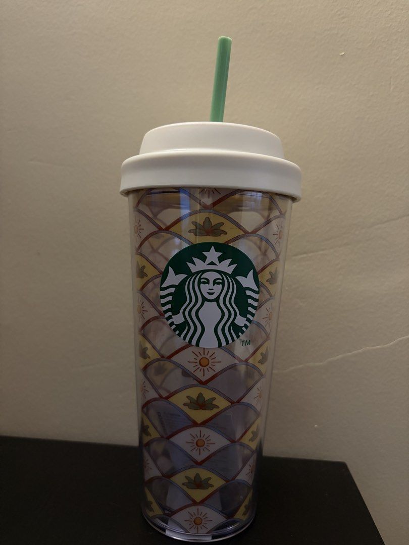 Starbucks Patterned Tumbler with Lid and Straw (Category: Water Bottles & Tumblers) located in Caloocan City. Submitted by lunarrocker_77 (Listing ID 1465830003, Image 1). Description: - Authentic Starbucks cold cup tumbler - Clear acrylic body with colorful geometric sun and leaf tile patterns - Prominent green Starbucks siren logo on the front - Includes white screw-on lid and pastel green straw - Ideal for cold drinks and iced coffee on the go