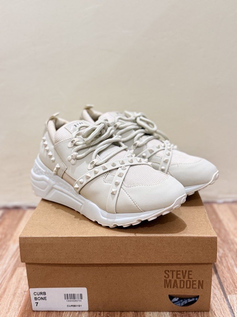 Steve Madden Curb Bone Sneakers (Category: Sneakers) located in Quezon City. Submitted by cndcvrtc (Listing ID 1465939108, Image 1). Description: - Brand: Steve Madden - Model: Curb - Color: Bone - Size: US 7 - Design: Chunky white soles with edgy studded strap overlays - Closure: Front lace-up - Inclusion: Original shoebox with authentic style, color, and size label - Condition: Excellent / brand new.