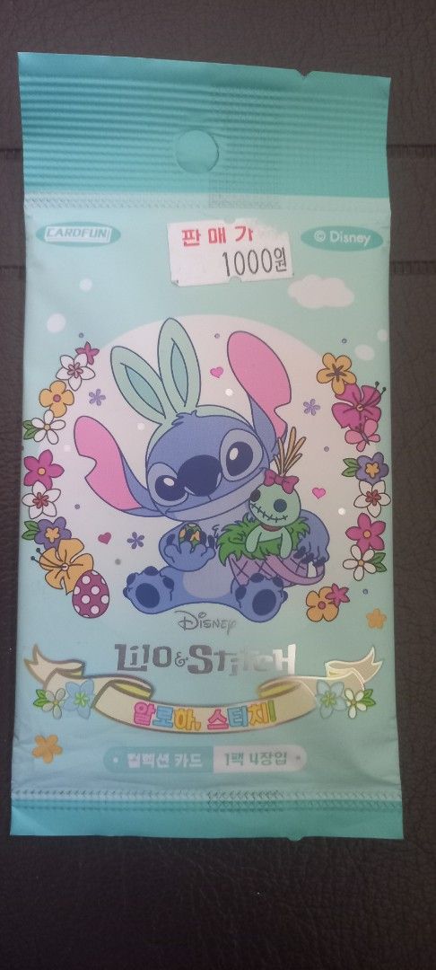 Stitch (Category: Raw Singles) located in Manila. Submitted by fmpc7878 (Listing ID 1465782706, Image 3). Description: - Brand: Cardfun (Official Disney Lilo & Stitch merchandise) - Edition: Korean Edition, manufactured in 2025 Condition: Brand new, factory sealed foil pack - Packaging: Cute pastel blue design with floral accents and Stitch holding his doll - Contents: Random collectible trading cards inside - Perfect for Disney collectors and St