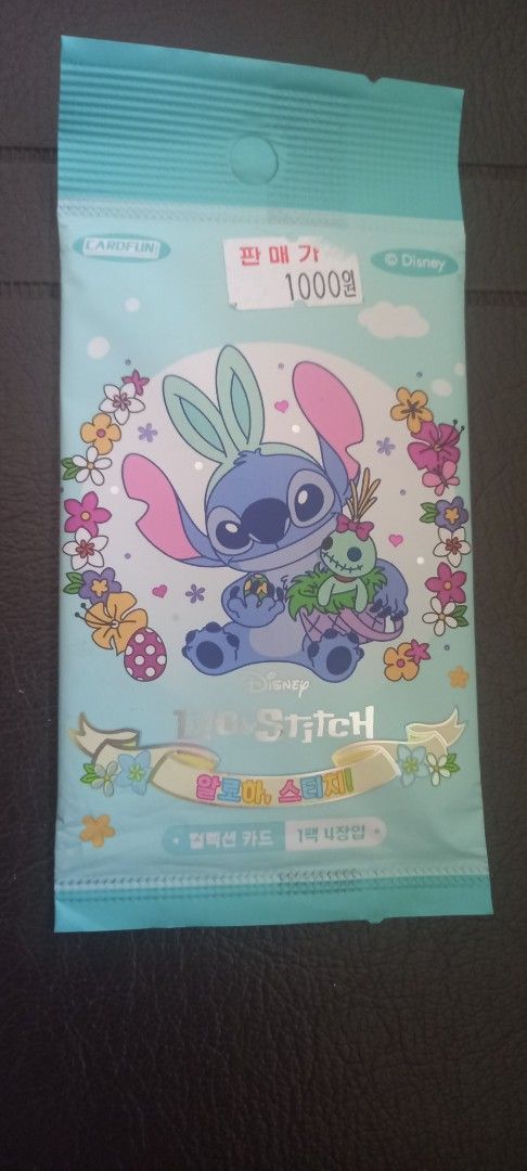 Stitch (Category: Raw Singles) located in Manila. Submitted by fmpc7878 (Listing ID 1465782706, Image 1). Description: - Brand: Cardfun (Official Disney Lilo & Stitch merchandise) - Edition: Korean Edition, manufactured in 2025 Condition: Brand new, factory sealed foil pack - Packaging: Cute pastel blue design with floral accents and Stitch holding his doll - Contents: Random collectible trading cards inside - Perfect for Disney collectors and St
