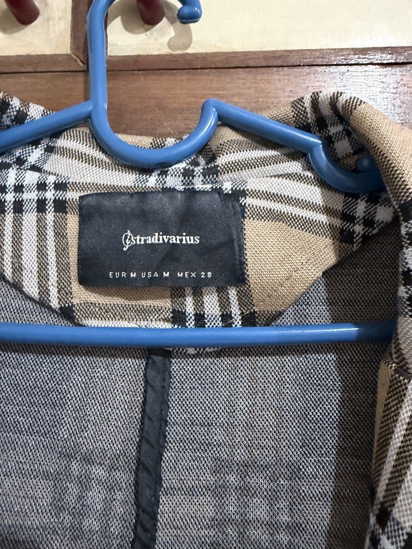 Stradivarius Plaid Long Coat Size M (Category: Coats, Jackets and Outerwear) located in Manila. Submitted by preloved_new_forsale (Listing ID 1465919928, Image 3). Description: - Brand: Stradivarius - Size: M - Pattern: Beige, black, and white plaid - Features: Single button closure, notched lapel, structured shoulders, and two front pockets - Length: Knee-length - Condition: Clean, well-kept appearance.