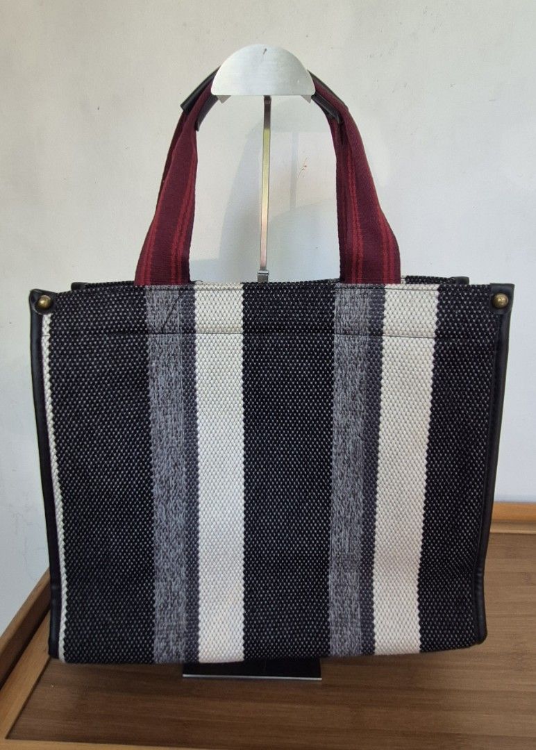 Striped Canvas Tote Bag with Maroon Straps (Category: Tote Bags) located in Manila. Submitted by shandarfa49055 (Listing ID 1465838916, Image 2). Description: Medium Woven Tote Bag – Good as New 👜 Stylish woven tote bag with black, white, and gray striped design and burgundy handles. Spacious and lightweight, perfect for work, shopping, travel, or everyday use. ✨ Condition: Good as New ✔️ No brand ✔️ Clean inside and out ✔️ Minimal to no signs o