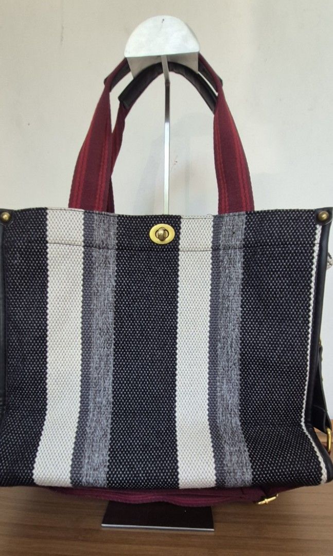 Striped Canvas Tote Bag with Maroon Straps (Category: Tote Bags) located in Manila. Submitted by shandarfa49055 (Listing ID 1465838916, Image 1). Description: Medium Woven Tote Bag – Good as New 👜 Stylish woven tote bag with black, white, and gray striped design and burgundy handles. Spacious and lightweight, perfect for work, shopping, travel, or everyday use. ✨ Condition: Good as New ✔️ No brand ✔️ Clean inside and out ✔️ Minimal to no signs o