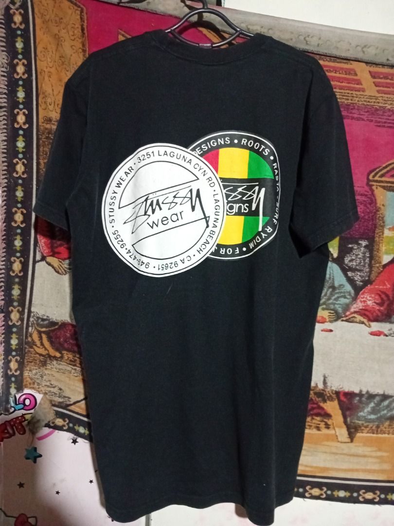 Stussy Rasta Designs Graphic Tee Black (Category: Tshirts & Polo Shirts ) located in Iloilo. Submitted by luckytiger.c90343 (Listing ID 1465917836, Image 2). Description: - Brand: Stüssy - Color: Black - Material: Soft 100% cotton - Fit: Standard fit, short sleeves, crew neck - Design: Small front circle print with a matching oversized rasta color block stripe graphic on the back - Condition: Good .