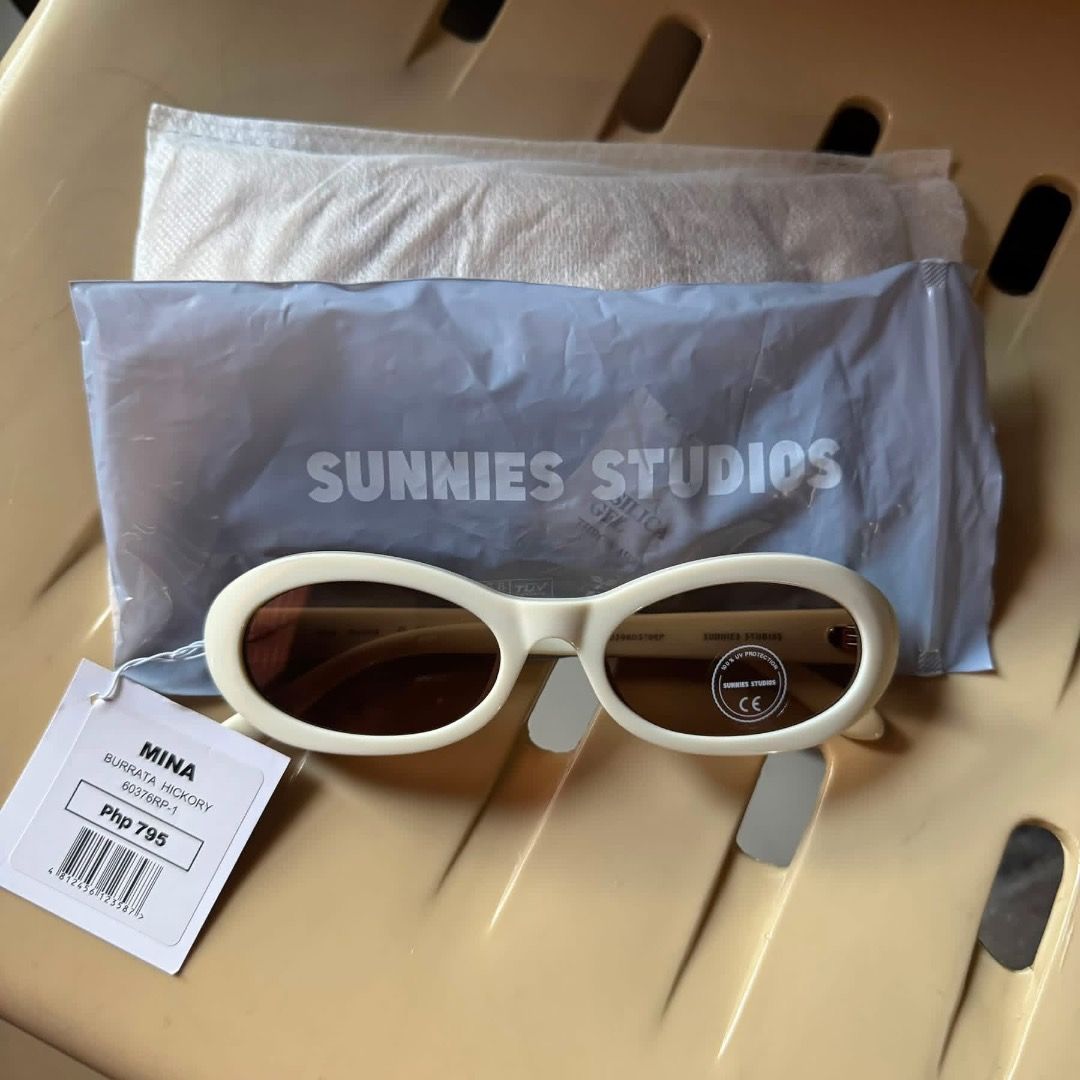 Sunnies Studios Mina Burrata Hickory Sunglasses (Category: Sunglasses & Eyewear) located in Manila. Submitted by koalalangot (Listing ID 1465879514, Image 1). Description: - Brand: Sunnies Studios - Model: Mina - Colorway: Burrata Hickory (Thick cream white frames with dark brown lenses) - Condition: Brand new, unused, with original tags and lens sticker still attached - Inclusions: Original branded pouch and protective packaging - Style: Minimal
