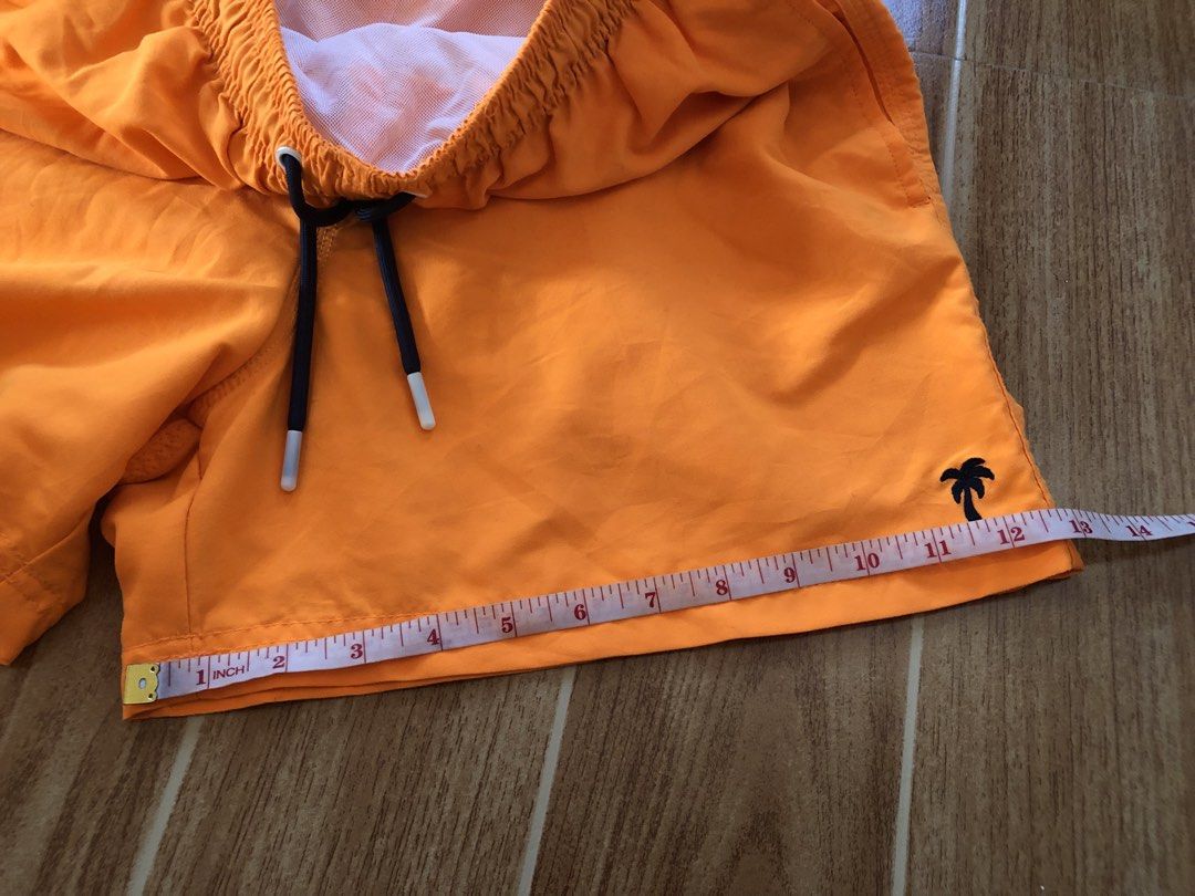 Sunset Beach Orange Swim Shorts (Category: Swim Trunks & Board Shorts) located in Tarlac. Submitted by f8njcgvfqy90581 (Listing ID 1465897027, Image 3). Description: - Brand: Sunset Beach - Color: Bright orange with black drawstring and white aglets - Features: Built-in white mesh lining, single back pocket with flap and brand label, subtle palm tree embroidery - Length: 15 inches - Ideal for: Swimming, pool days, and beach getaways.
