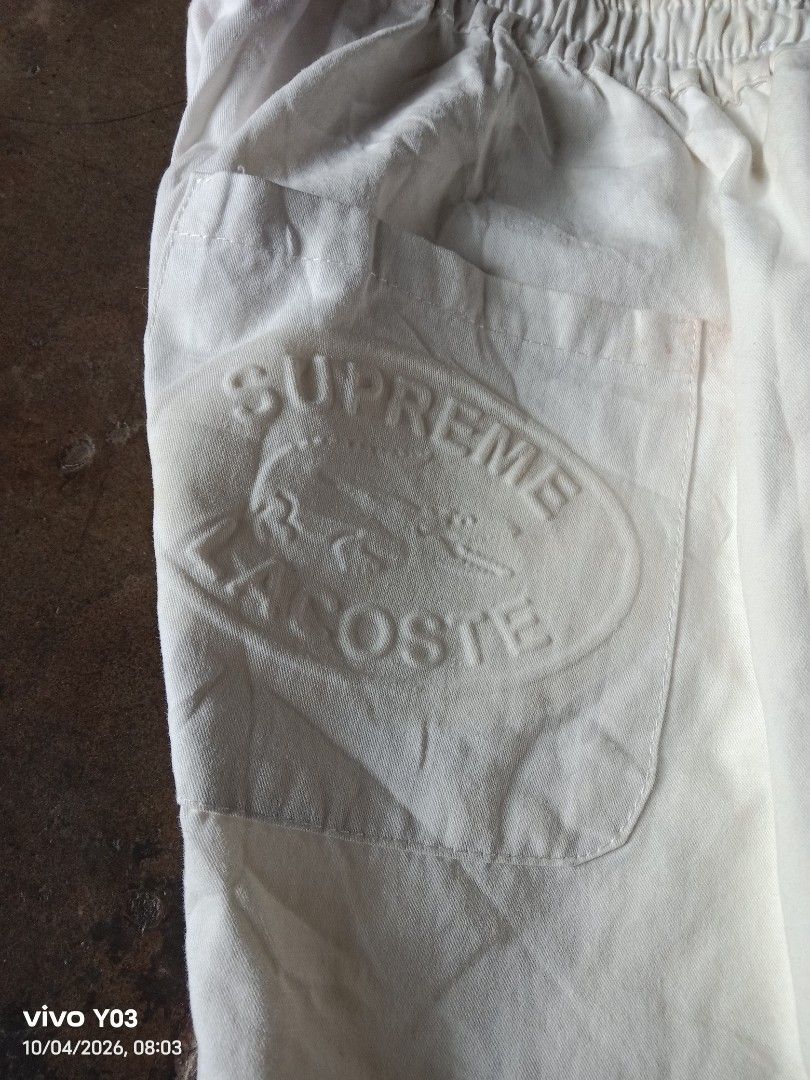 Supreme x Lacoste White Shorts (Category: Shorts) located in Cabuyao City. Submitted by blake657 (Listing ID 1465760501, Image 3). Description: - Authentic Supreme x Lacoste collaboration shorts in clean white - Comfortable elastic waistband with adjustable drawstring - Convenient right-side pocket featuring stylish embossed branding - Iconic embroidered Lacoste crocodile patch near the bottom hem - Lightweight and breathable fabric, perfect for 