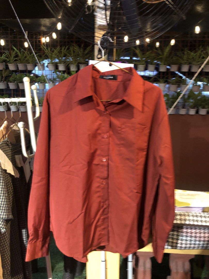 Suyan Brick Red Long Sleeve Button-Up Shirt (Category: Longsleeves) located in Cauayan City . Submitted by wholly.craaaft (Listing ID 1465876845, Image 1). Description: - Brand: Suyan - Color: Brick red - Fit: Relaxed fit with a curved hem - Details: Long sleeves, classic collar, single front pocket, standard button-down closure - Material: Soft and comfortable - Versatile basic piece, great for layering or wearing solo with jeans or slacks.