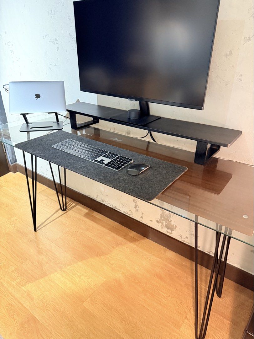 Table with glasstop (Category: Tables & Sets) located in Taguig. Submitted by boxedgoodies (Listing ID 1465881616, Image 2). Description: - Desk with glass top and stylish black metal hairpin legs - Solid Mahogany wood in Walnut finish - Leg height is 70cm - Wood is 40cmx138cm - Wood thickness is 1in - Glasstop is 48cmx 155cm.