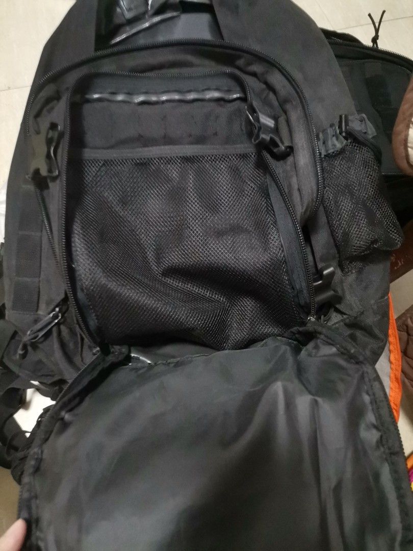 Tactical black backpack multi compartment heavy duty (Category: Backpacks) located in Makati City. Submitted by kookybearsstuff (Listing ID 1465818118, Image 3). Description: - Color: Black - Material: Sturdy, heavy-duty build - Compartments: Multiple zipped compartments and inner pockets - Front Features: Bungee cord webbing and Velcro patch area - Strap Details: Includes a small detachable pouch and D-rings - Condition: Zippers work perfectly, 