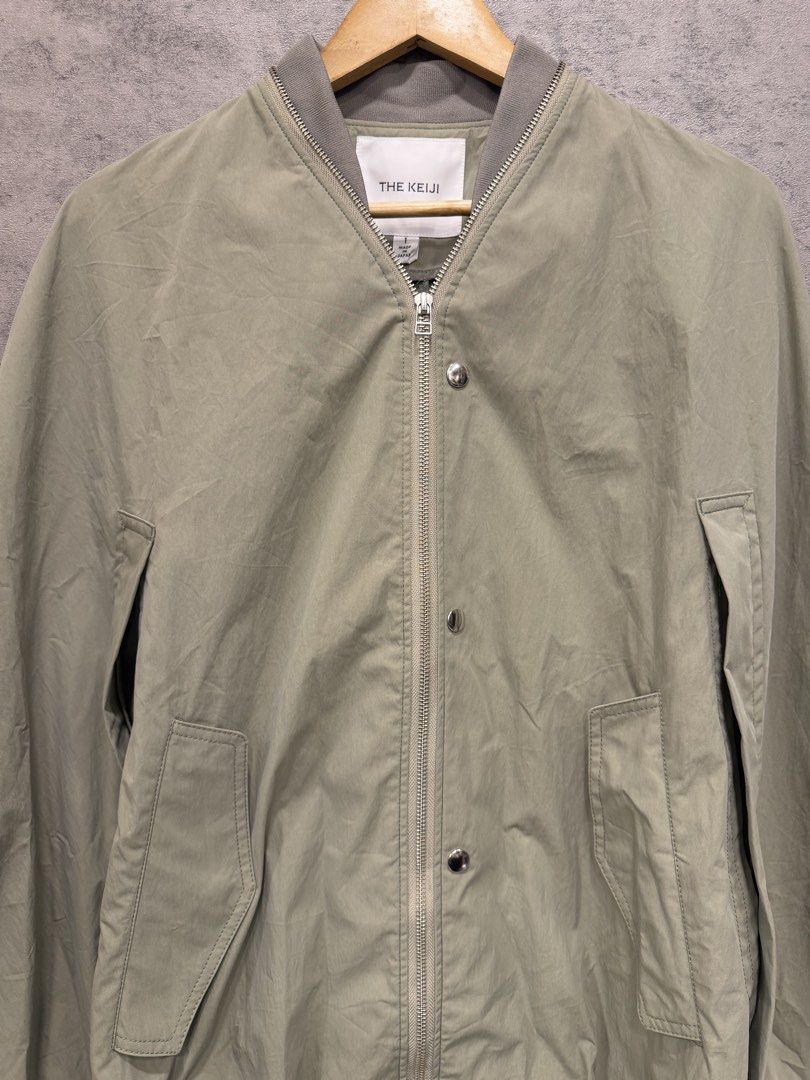 THE KEIJI - MA-1 CAPE COAT (Category: Coats, Jackets and Outerwear) located in Makati City. Submitted by daboy_ (Listing ID 1465945802, Image 2). Description: Size: 1 Condition: 10/10 Made in: Japan Material: BODY: COTTON 70% NYLON 30% RIB: POLYESTER 80% NYLON 18% POLYESTER 2% PIPING: CUPRO 100% This MA-1 style cape coat features an eye-catching balloon-like circular silhouette. The zipper that runs all the way around from the front to the neckli