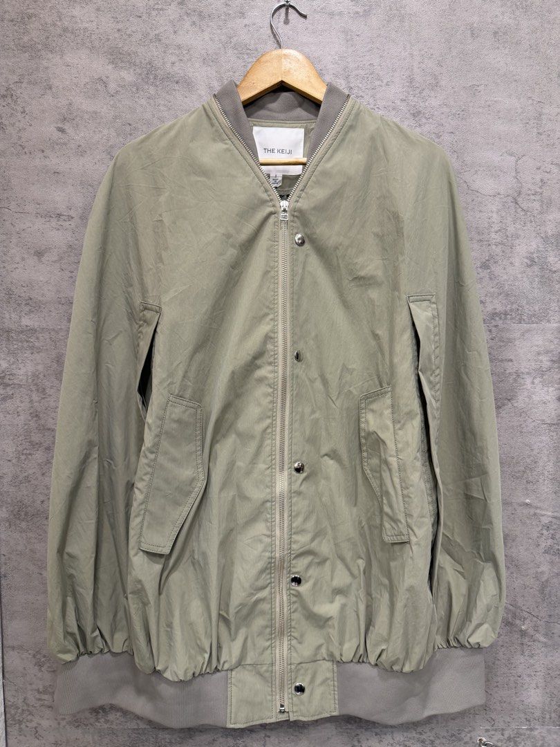 THE KEIJI - MA-1 CAPE COAT (Category: Coats, Jackets and Outerwear) located in Makati City. Submitted by daboy_ (Listing ID 1465945802, Image 1). Description: Size: 1 Condition: 10/10 Made in: Japan Material: BODY: COTTON 70% NYLON 30% RIB: POLYESTER 80% NYLON 18% POLYESTER 2% PIPING: CUPRO 100% This MA-1 style cape coat features an eye-catching balloon-like circular silhouette. The zipper that runs all the way around from the front to the neckli