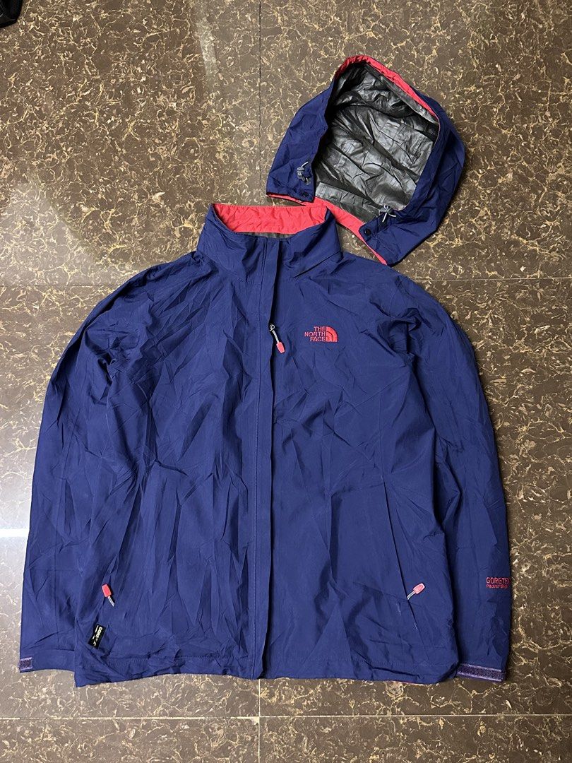 The North Face Gore-Tex Paclite Shell Jacket Navy Size L (Category: Coats, Jackets and Outerwear) located in Padada. Submitted by jevanie1234 (Listing ID 1465765803, Image 1). Description: - Brand: The North Face - Color: Navy blue with red accents - Size: Large - Material: Lightweight & packable Gore-Tex Paclite Shell - Features: Detachable adjustable hood, branded zipper pull tabs, embroidered red logos on chest and sleeve - Condition: Great pr
