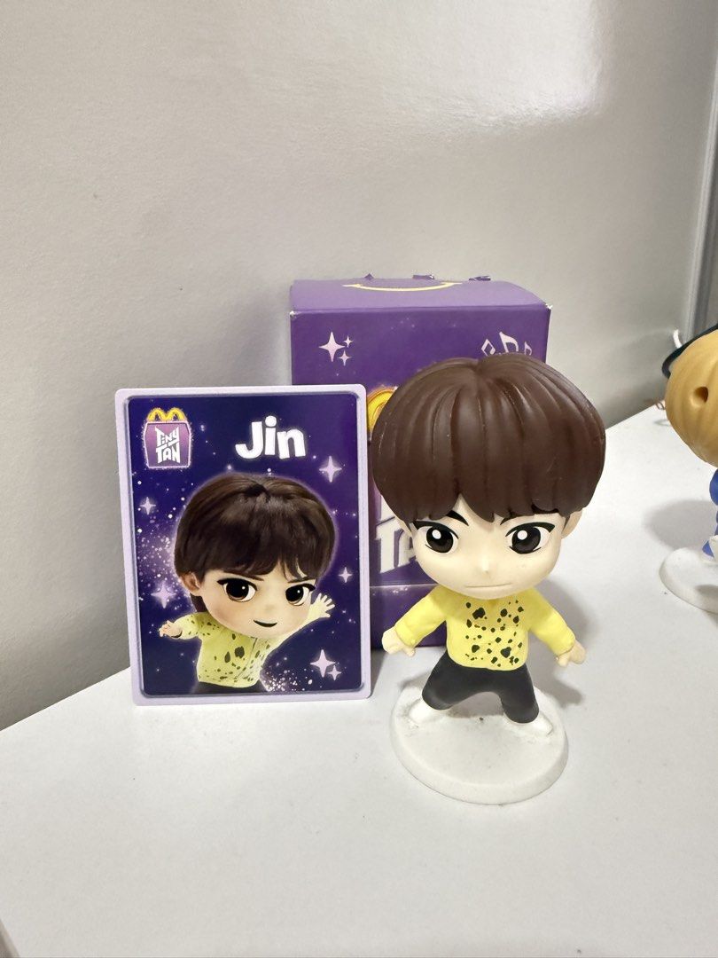 TinyTAN Jin McDonald's Figure with Card and Box (Category: Designer & Blind Box Toys) located in Quezon City. Submitted by hooniecart0 (Listing ID 1465901383, Image 1). Description: - Official McDonald's TinyTAN Jin (BTS) collectible figure - Features Jin in his iconic yellow patterned long sleeve shirt and black pants - Includes white base stand, matching purple photocard, and original box - 100% authentic and well-maintained - Must-have for BTS