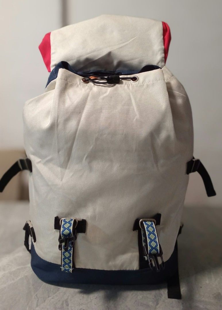 Titicaca Colorblock Canvas Backpack Multicolored (Category: Backpacks) located in Manila. Submitted by cosmiccloud-9236 (Listing ID 1465813486, Image 3). Description: - Brand: Titicaca - Material: Multicolored canvas - Colorway: White main body, light blue flap and bottom, bright yellow front pocket, red accents, and navy blue back - Straps: Adjustable red and yellow shoulder straps, plus geometric pattern buckle straps on the front - Closure: Dr