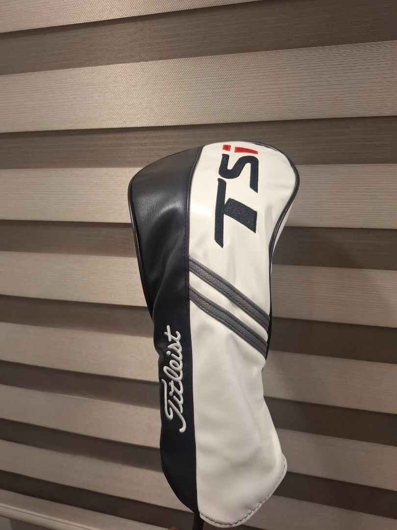 Titleist TSi2 Driver (Category: Golf) located in Manila. Submitted by wongkarwai77 (Listing ID 1465915164, Image 1). Description: - Authentic Titleist TSi2 Driver with matching white and black headcover - Shaft: Diamana TM 55 S graphite shaft with standard golf grip - Adjustability: Adjustable hosel settings near the adapter for custom ball flight - Condition: Clubhead shows normal ball marks on the face and minor swirling on the crown from stand