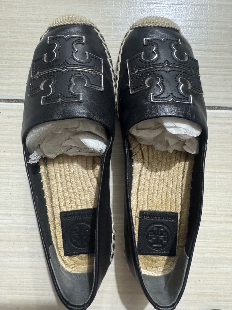 Tory Burch Black Leather Logo Espadrilles (Category: Flats & Sandals) located in Manila. Submitted by gulia21 (Listing ID 1465923456, Image 1). Description: - Brand: Tory Burch - Material: Premium black leather upper with jute braided sole - Design: Slip-on espadrilles featuring a large silver-toned cutout logo - Interior: Comfortable leather inner sole with stamped brand logo - Condition: Excellent, structured shape carefully maintained with pap