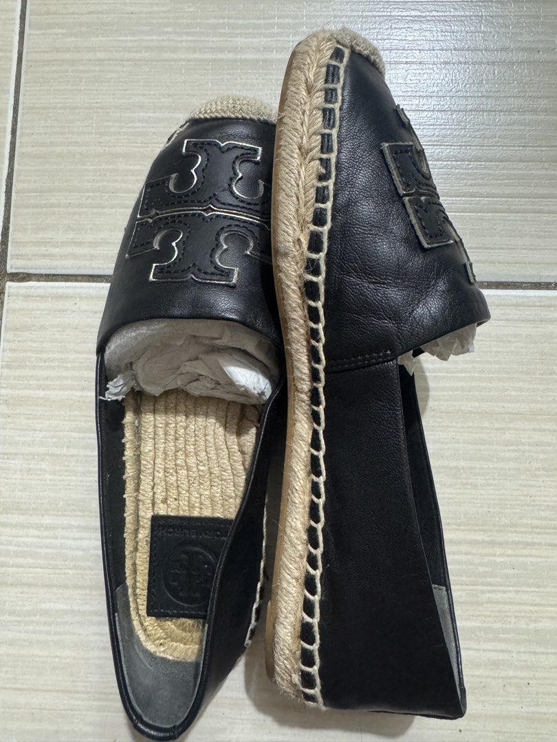 Tory Burch Black Leather Logo Espadrilles (Category: Flats & Sandals) located in Manila. Submitted by gulia21 (Listing ID 1465923456, Image 2). Description: - Brand: Tory Burch - Material: Premium black leather upper with jute braided sole - Design: Slip-on espadrilles featuring a large silver-toned cutout logo - Interior: Comfortable leather inner sole with stamped brand logo - Condition: Excellent, structured shape carefully maintained with pap