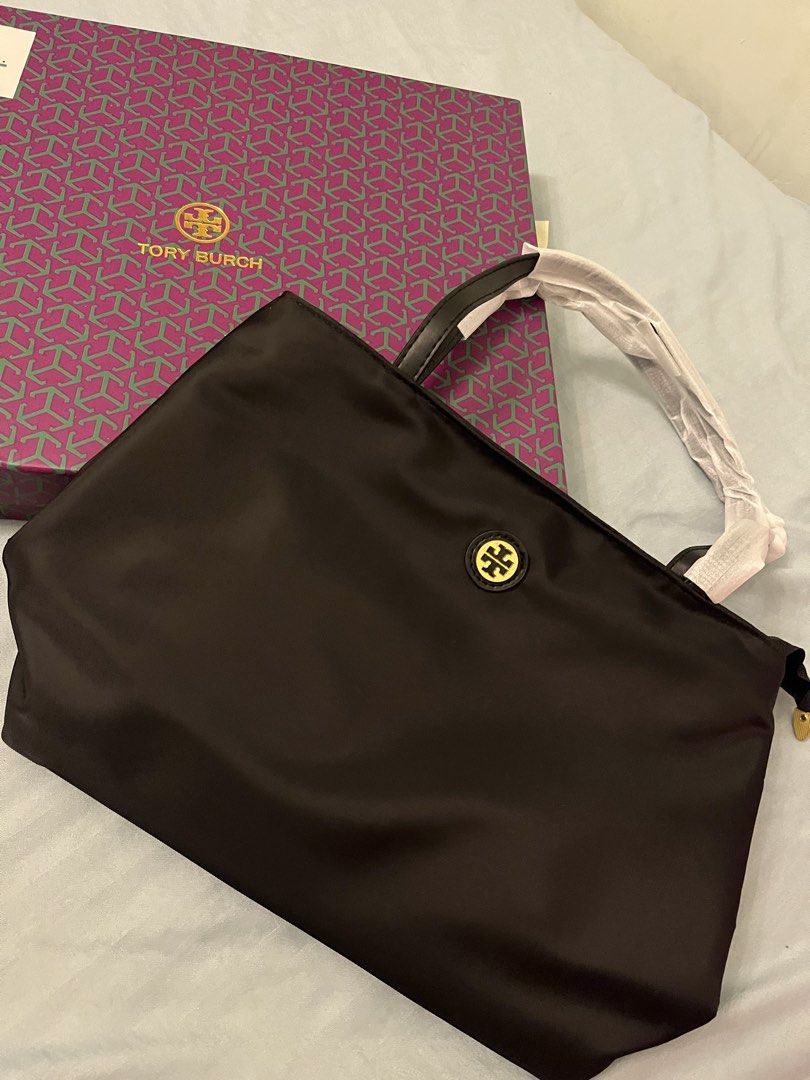 Tory Burch Black Nylon Tote Bag with Box (Category: Tote Bags) located in Caloocan City. Submitted by dubaichewycooki (Listing ID 1465761797, Image 1). Description: - Brand: Tory Burch - Material: Durable black nylon - Hardware: Gold-tone with centered logo plaque - Condition: Brand new, unused, with wrapping still on straps - Features: Double handles (wrapped in protective paper) and a spacious interior for daily essentials - Inclusions: Comes w